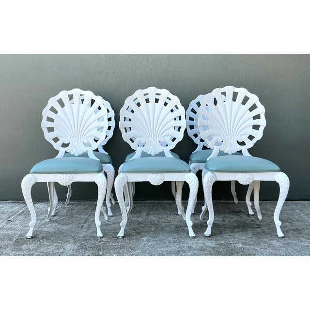 A striking set of six vintage cast aluminum shell-back grotto chairs, combining the playful fantasy of rococo revival...