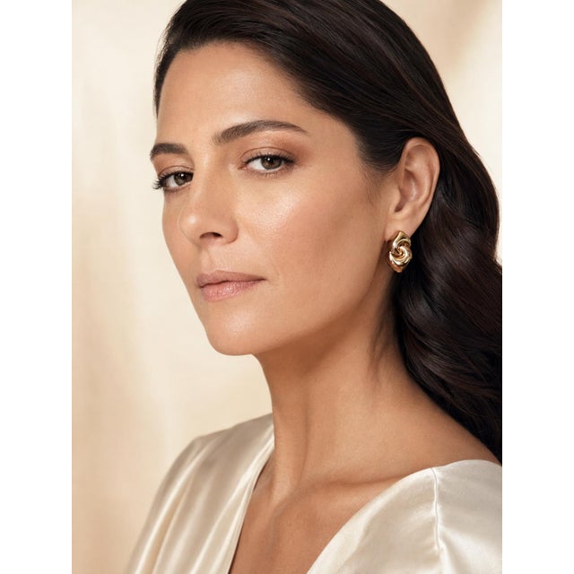A sculptural pair of Bulgari Gancio earrings, crafted in highly polished 18-karat yellow gold. Each earring features two...