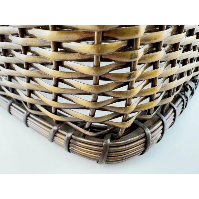 A distinctive vintage tissue box cover crafted in an intricate basket-weave design of brass-tone metal. Flattened woven...