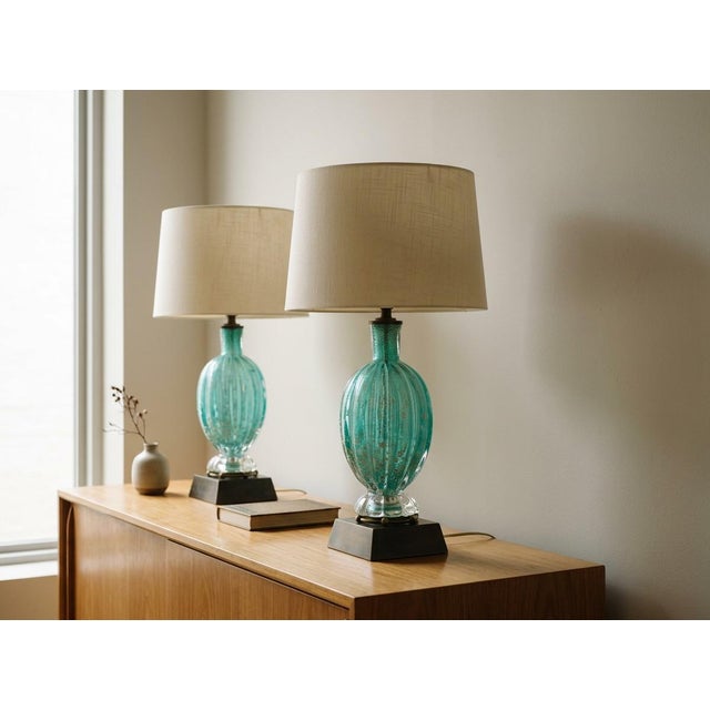 A pair of Mid Century Murano glass lamps by Barovier & Toso. Beautiful teal color with controlled bubbles and silver...