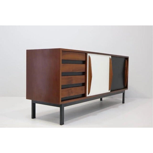 Sideboard designed by Charlotte Perriand, circa 1960. Produced by Steph Simon (France). Steel base, wooden frame and...