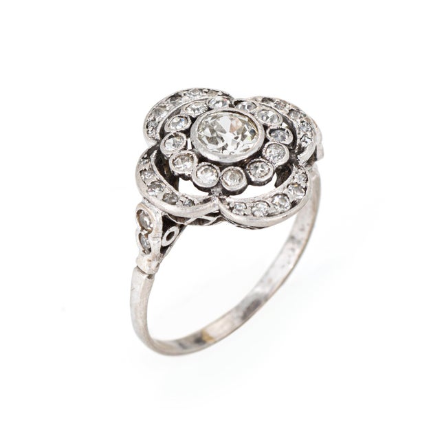 Stylish vintage diamond cluster ring crafted in 14k white gold (circa 1950s). Old European cut diamond (center) is...