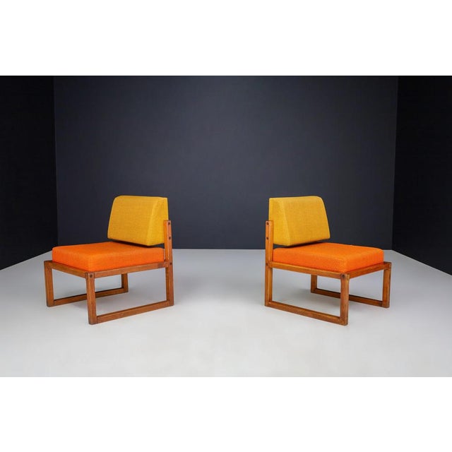 Introducing a visually striking pair of vintage lounge chairs designed by the esteemed French furniture designer André...