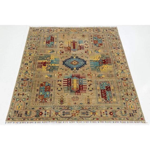 Transform your living space with this modern Kazak-style rug, which combines traditional tribal artistry with contemporary...