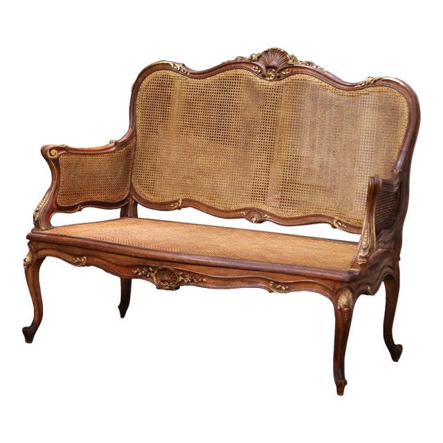 Early 20th Century French Louis XV Style Walnut and Cane Settee With Parcel Gilt For Sale