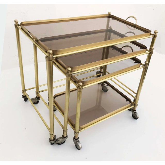 Superb set of Nesting table by Maison Lancel, each one with a removable tray. Bronze and smoke glass, all table on wheels....