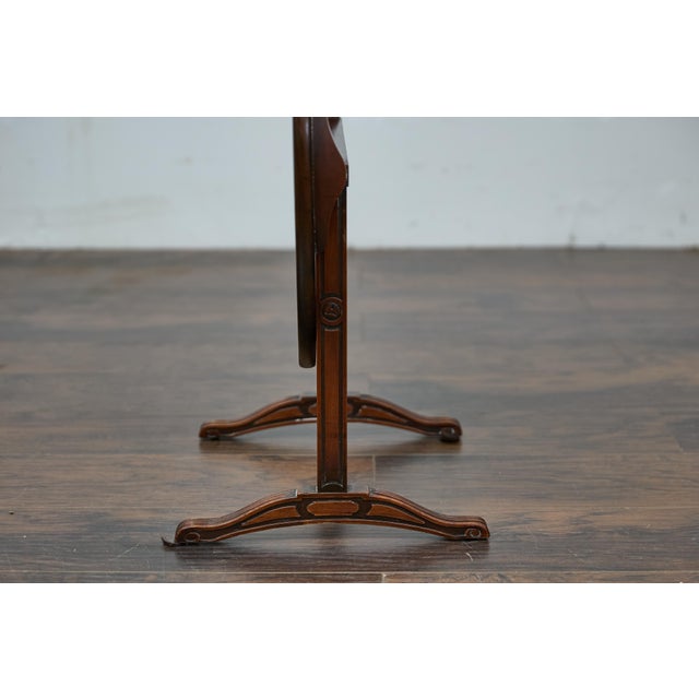 A French Louis-Philippe walnut wine tasting table from circa 1820-1850 with tilt top and paw feet. Elevate your space with...