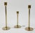 Vintage mid-century modern set of three brass tulip candlesticks with graduated heights. Tallest 9"H, shortest at 6"H....