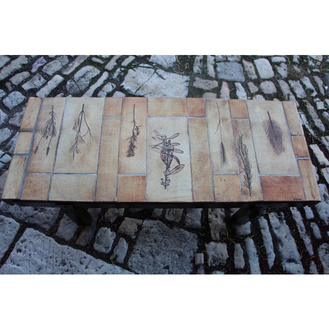 Coffee table designed by Roger Capron, in Les Herbiers ceramic tile top, wooden base in good condition This piece has an...