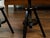 A pair of American adjustable artist's stools from the early 20th century, with black finish. Made in the USA during the...