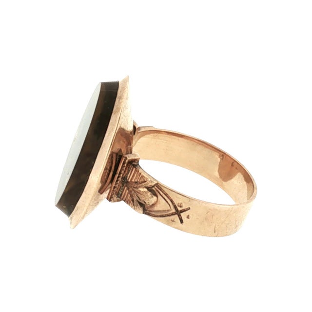 A Victorian statement ring featuring a variegated brown agate set in 14k gold. The ring has beautiful details on the side...