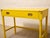 A fantastic vintage writing desk with a bold lacquered yellow finish and a playful mix of Hollywood Regency and campaign-...