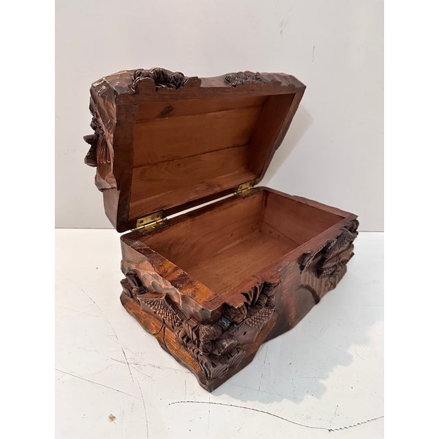 Gorgeous heavily carved keepsake box. Very thick wood. The details of a village and trees beautifully rendered. It has a...
