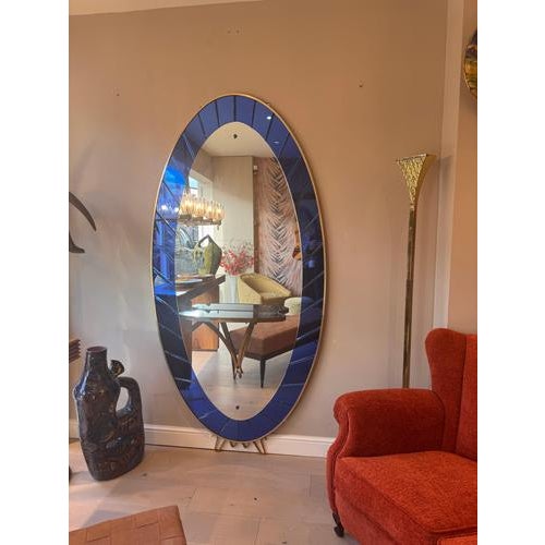 A majestic oval shaped mirror & console table featuring a gorgeous cobalt blue mirrored glass panels to the frame with a...