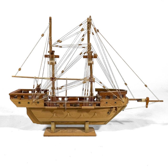 A wonderful piece of folk art, this wooden sailing ship crafted by J. Romero (signed on the base) is intricately detailed,...