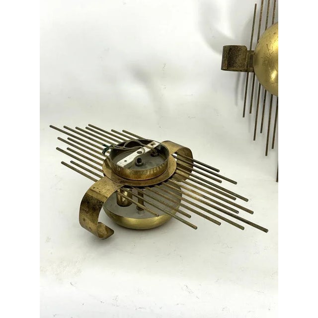 Rare set of three gilded metal wall lamps produced in Italy during the 50s. Fair vintage condition with loss of gilding...