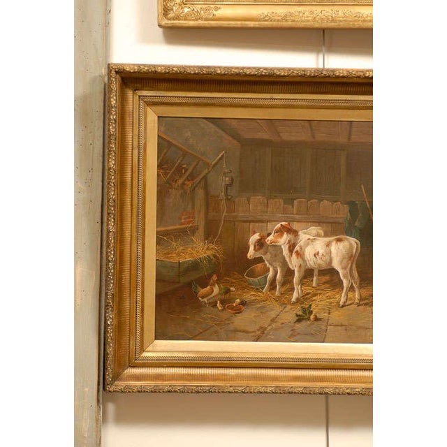 An English 19th century oil on canvas painting depicting farm animals in a barn in giltwood frame. This English farm...
