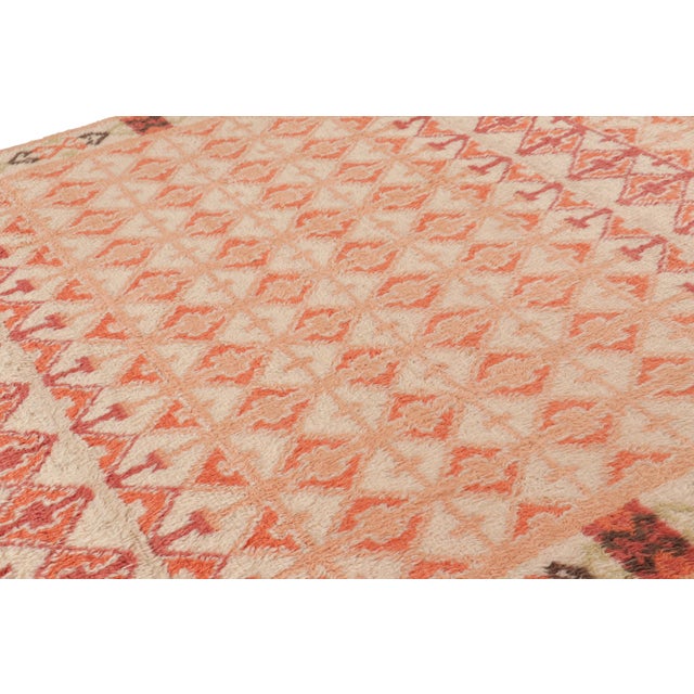 Hand-knotted in wool, this 8x10 contemporary Moroccan style rug features a lush pile texture and geometric patterns...