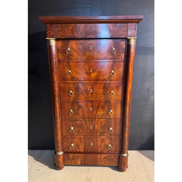 A stunning French Empire Tall Chest of Drawers. I have never seen one of these dimensions being narrow. Made of Flame...