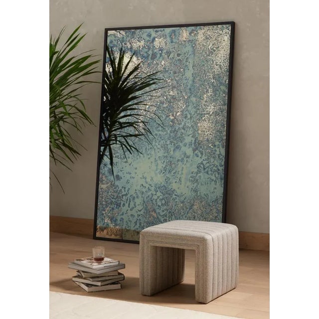 Layer in an extra surface or seat with a linen-blend ottoman in a crisp heathered grey, with heavy channeling for texture....