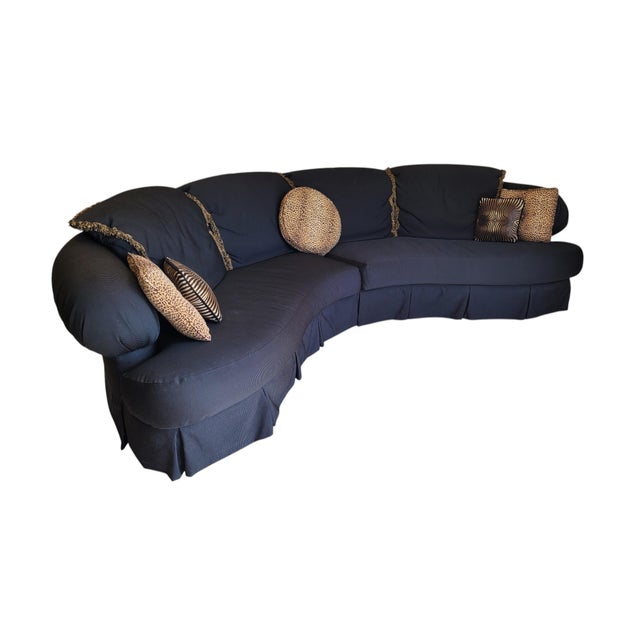 Striking late 1980s–early 1990s two-piece sectional sofa with an expansive serpentine silhouette, dramatic rolled arms,...