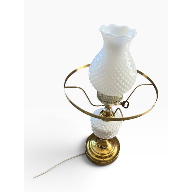 Striking vintage electric hurricane table lamp featuring richly textured white hobnail milk glass, polished brass-tone...