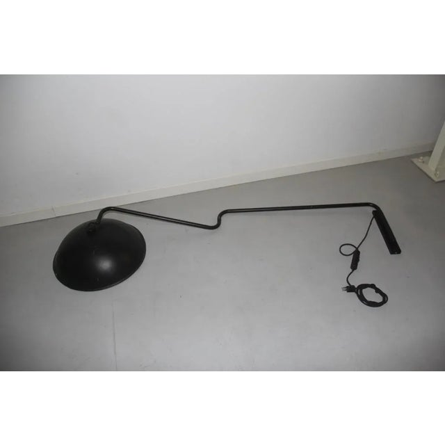 This extendable wall lamp from Ecoluce was made during the 1970s and is lacquered in black. This piece has an attribution...