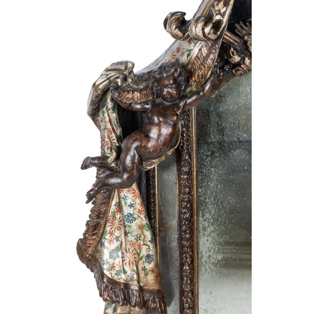 An exquisite and highly decorative Italian late 18th century venetian mirror, embodying the theatrical elegance and...
