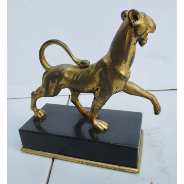 E.F Caldwell gilt bronze panther on black marble base. Gilt and marked E F Caldwell to the rim of the marble base. A...