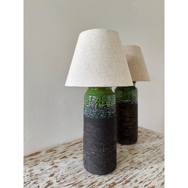 A pair of Tilgmans ceramic table lamps. Expressive stoneware table lamps with rought textured body and glazed top....