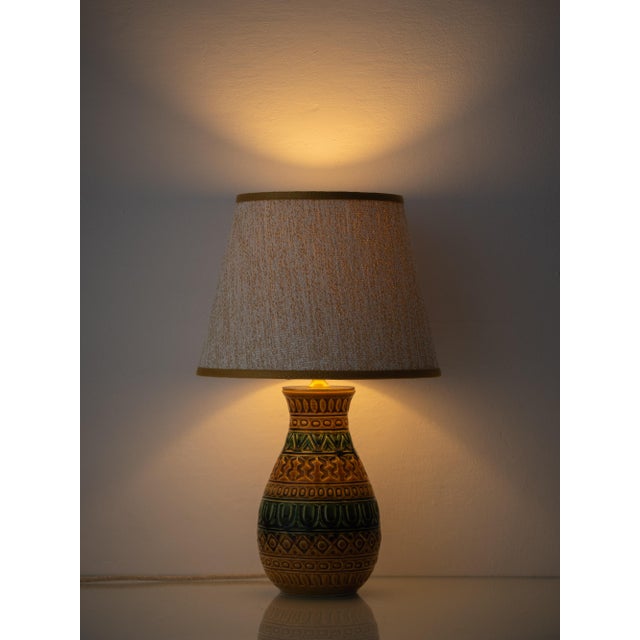 A small West German ceramic table lamp in the incised, geometric style of Aldo Londi's Bitossi pottery, worked in mustard...