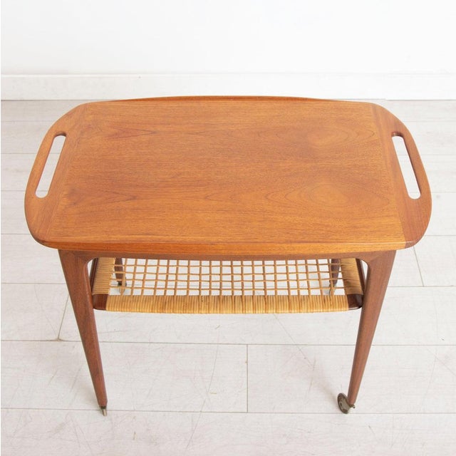A danish midcentury serving trolley by johannes andersen for silkeborg circa 1960s. The trolley has a removable top tray...