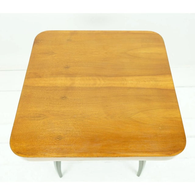 - From around 1930 - Ebonized feet and curved spider legs - Veneered softwood top - Rounded corners - Labeled on the...
