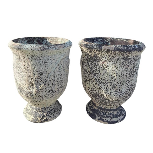 A matched pair of vintage terracotta garden planters featuring a heavily textured volcanic glaze in layered charcoal,...