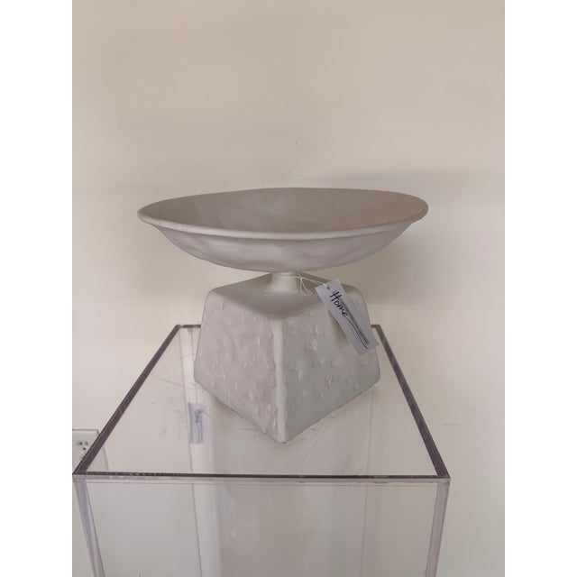 Contemporary display bowl crafted from aluminum, featuring a sleek sculptural silhouette with a matte white textured...