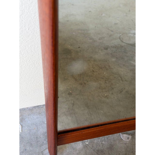 Beautiful vintage Danish teak wall mirror, dating to the early 1960s. Crafted in solid teak with clean architectural...