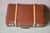 Filled with travel souvenirs, this 1940s suitcase is a beautiful retro piece. Its rigid cardboard shell is reinforced by...