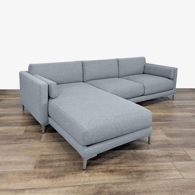 2 piece Sectional with chaise featuring track arms and metal legs. Brand: CB2. Model: District. Original Price: $1999....