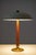An elegant Swedish modern table lamp executed in mahogany and brass, designed by Erik Tidstrand for Nordiska Kompaniet....
