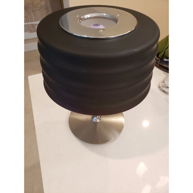 This listing consist of a Mid-Century modern italian lamp in a steel base with a fixed black glass shade. It's in Perfect...