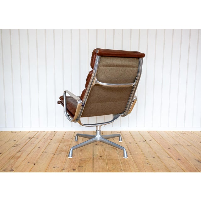 A gorgeous, iconic and rare 1970s tall back eames ‘soft pad’ swivel lounge chair in fair-to-good vintage condition....