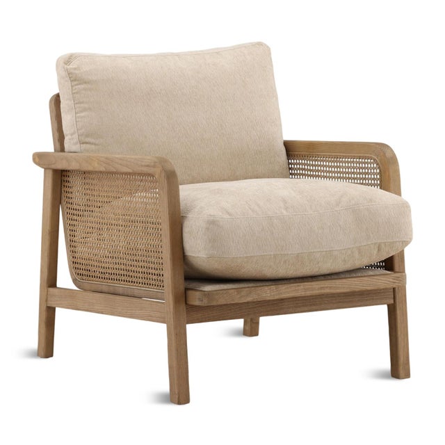 Relaxed sandy beige chenille upholstered cushions set in a wood and cane paneled frame arm chair. Each may vary in exact...
