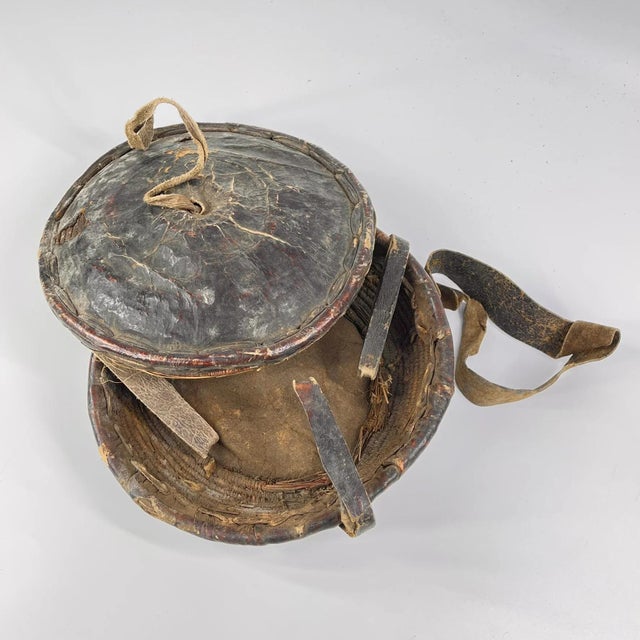 An Ethiopian leather-covered bread basket with a gorgeous patina. Baskets such as this are found among the Oromo and other...