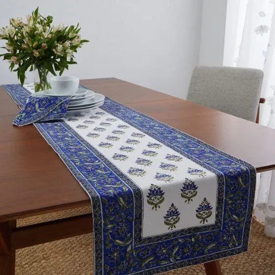 The Blossom design illustrates a traditional Indian flower motif set against a scrolling floral border for a beautiful...