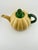 Vintage Weller Squash Teapot featuring a pumpkin shaped body with green handle and stem shaped cover. Part of the paper...