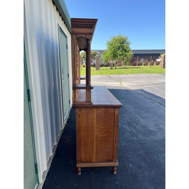 A very unique quarter sawn oak sideboard buffet with mirror from the early 20th century. The sideboard contains large...