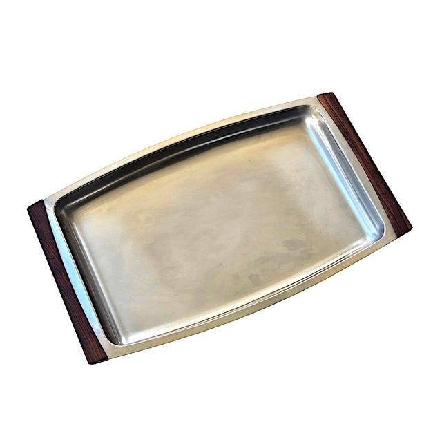Offered is a sleek and chic 1960s stainless steel tray/platter with rosewood handles designed by Arne Jacobsen for...