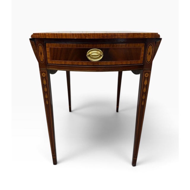 A finely crafted Councill Craftsmen Pembroke style inlaid mahogany side table, circa 1980s, showcasing exceptional...