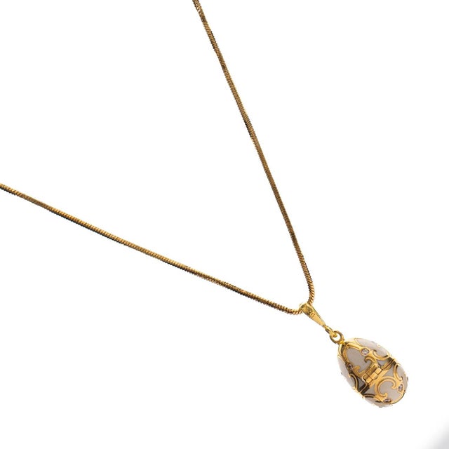 Embrace timeless elegance and good fortune with the Lucky Clover White Enamel Egg Gold Necklace. This enchanting piece...