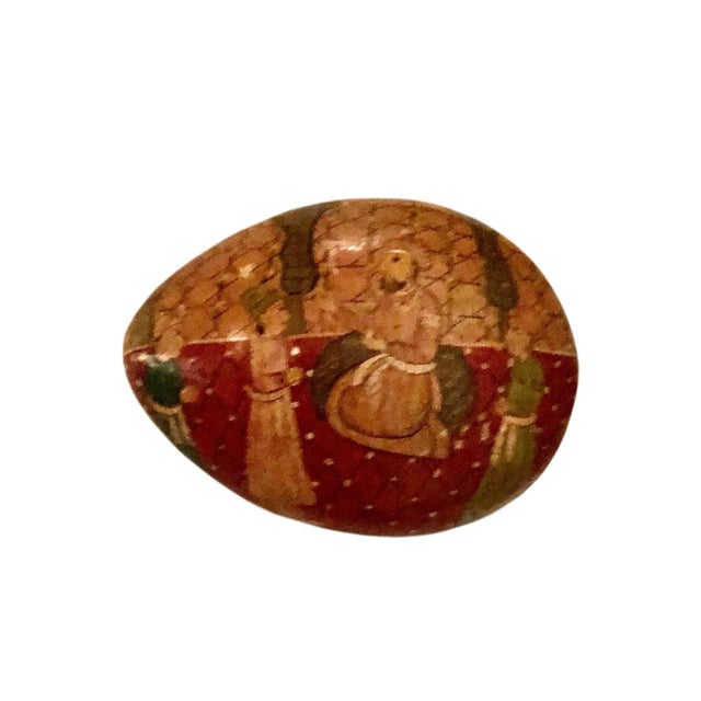 A lovely papier mâché box in the shape of an egg. The box is adorned with hand painted figures. Circa 1920s Kashmir, India.